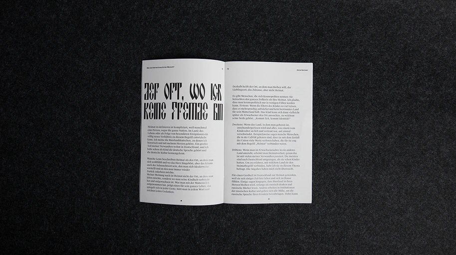 Essay spread with a deconstructed display headline opposite two columns of running text.